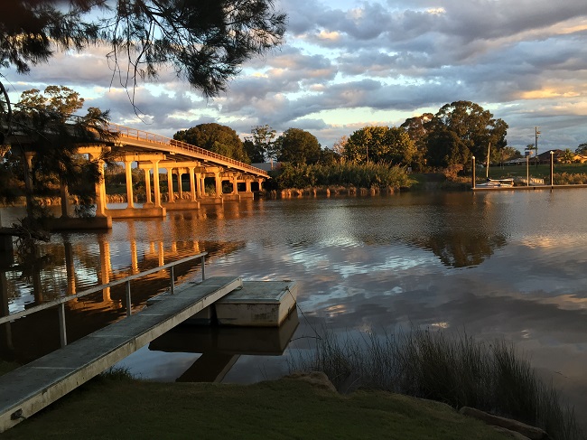The Cowper-Brushgrove bridge from the lawns of the Brushgrove hotel, with Top Shelf on the pontoon on the far side.