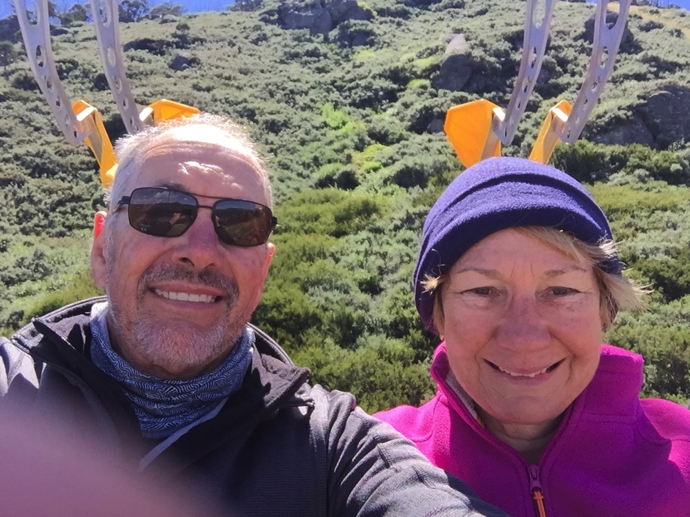 Hmm haven't quite mastered the art of the selfie. Clamps to attach mountain bikes to the ski lift behind our heads.