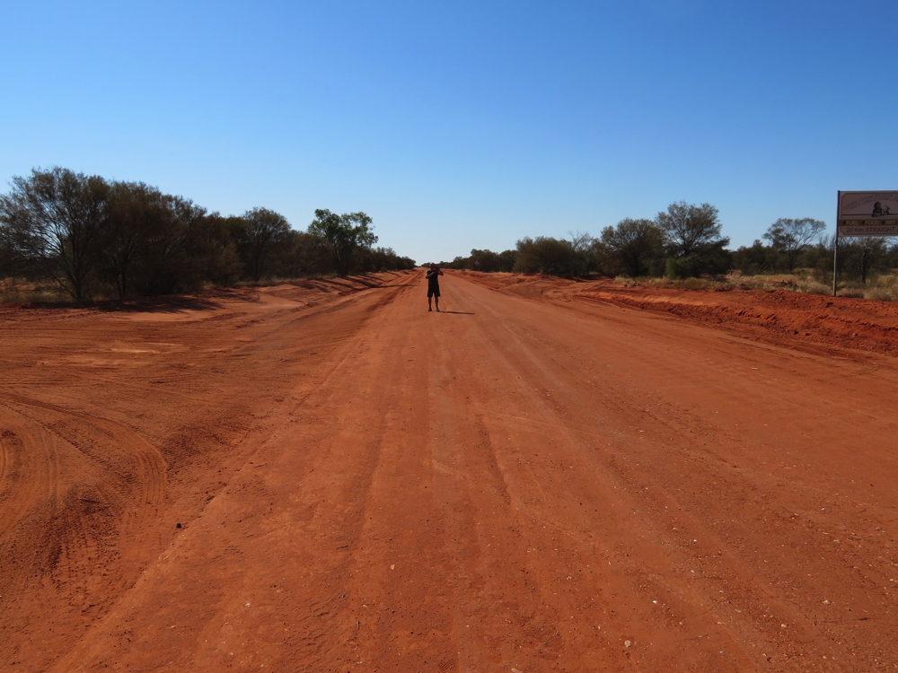 No idea what Ken is doing walking along this dusty red road.