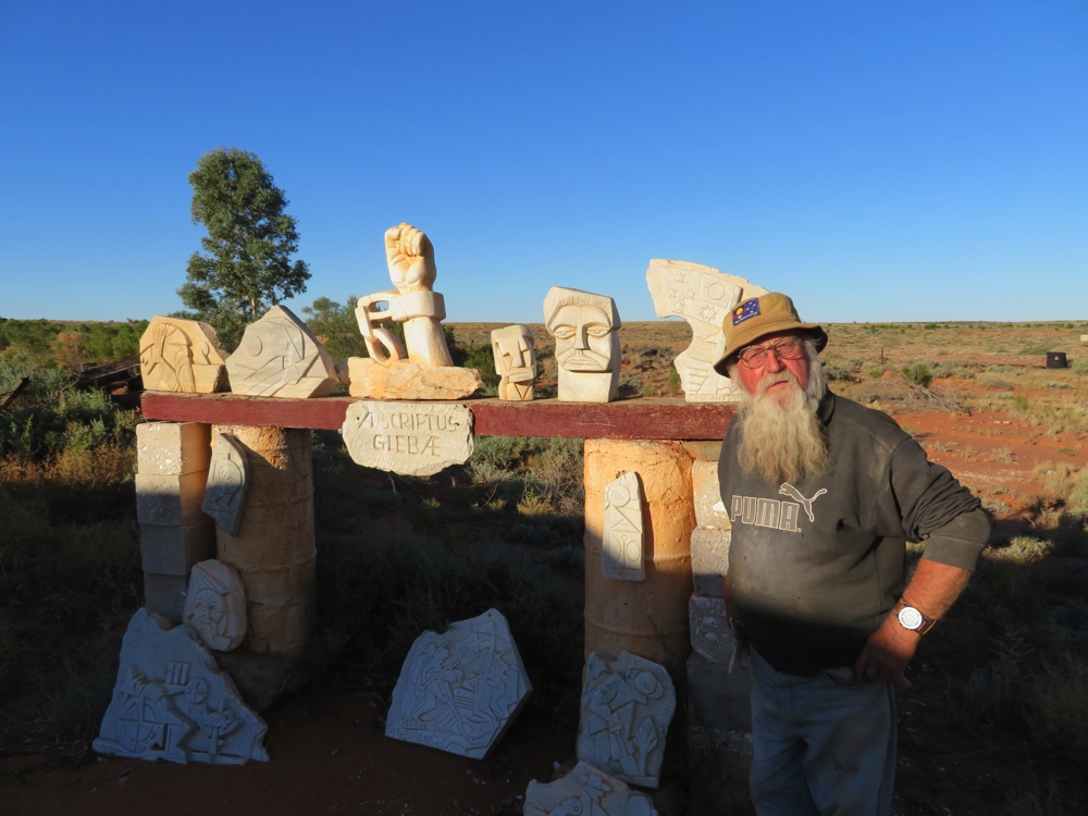 Talc Alf with just a few of his sculptures in his outdoor art gallery. Look closely at the flag on his hat.