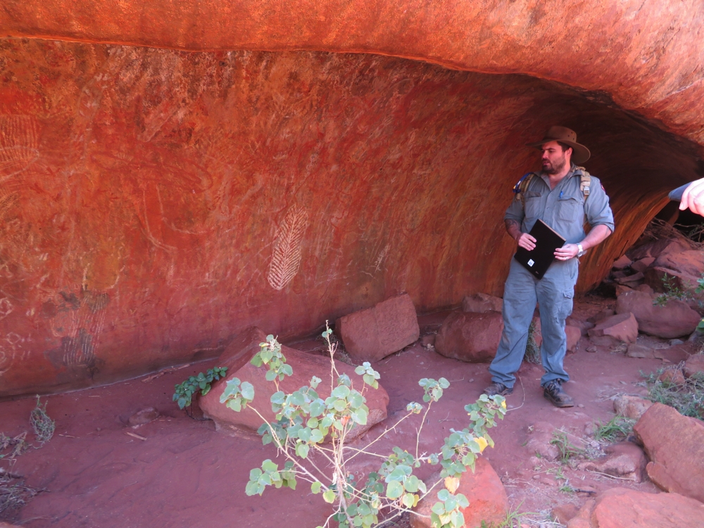Explaining the ways of the indigenous people who lived here - on the Mala walk.Uluru